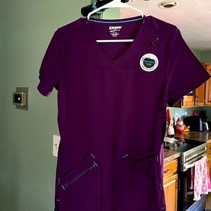 Scrub top with pockets eggplant color. Matching pants available